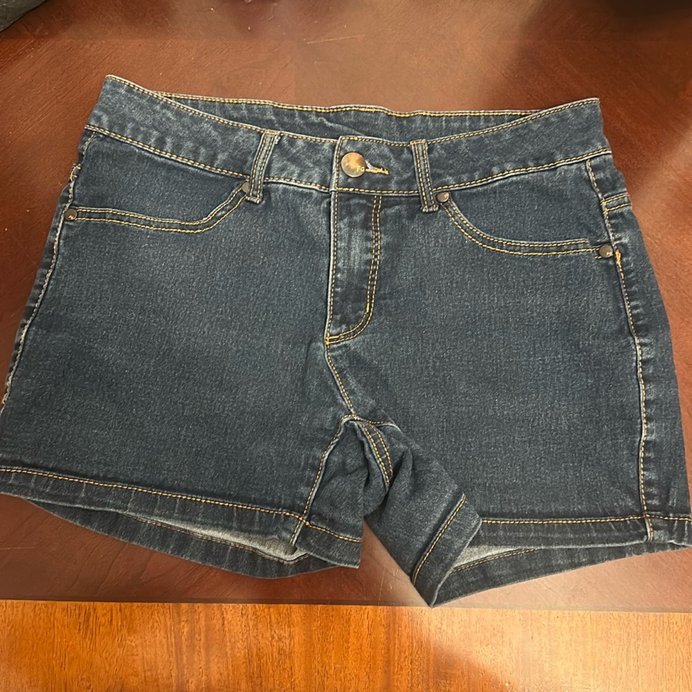 Dark wash denim shorts.